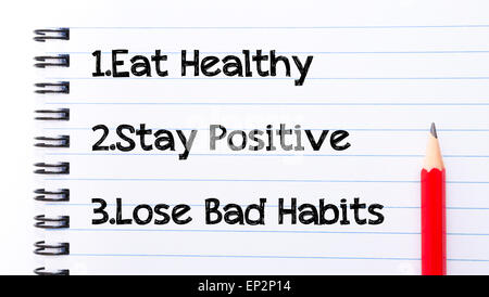 Essen Sie gesund, bleiben positiv, verlieren schlechte Gewohnheiten geschriebene Text auf Notizblockseite, roter Buntstift auf der rechten Seite. Motivations Begriff Bild Stockfoto