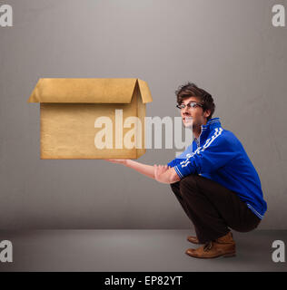 GOOG aussehenden Mann mit einer leeren braunen Karton Stockfoto