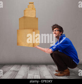 Junger Mann hält eine Reihe von braunen Kartons Stockfoto