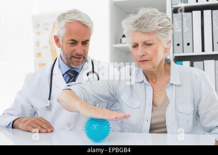 Männlichen Arzt mit älteren Patienten mit Stress Buster-ball Stockfoto