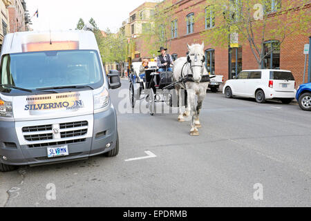 Touristen machen einen Abend Fahrt mit der Kutsche in der Innenstadt von Bend, Oregon, im Frühjahr. Stockfoto