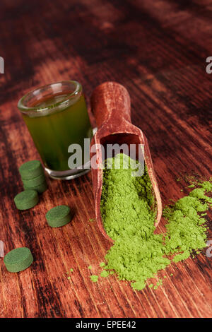 Nahrungsergänzung Spirulina und Chlorella und Weizen Grass auf hölzernen Hintergrund. Pillen, grüne Getränk und Boden Pulver. Stockfoto