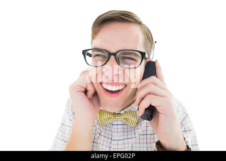 Geeky Hipster hält ein Retro-Handy Stockfoto