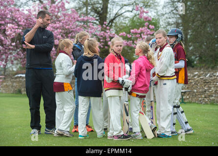 Junior Mädchen bereiten für ein Cricket-Match mit ihrem Trainer in Wiltshire, England Stockfoto