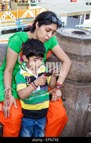 Mumbai Indien, Apollo Bandar, Colaba, Frau weibliche Frauen, Mutter, Sohn, Familie Familien Eltern Eltern Kind Kinder, Smartphone-Handys SMS, Toilette Stockfoto