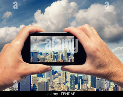 Mann und Frau Hand Skyline von New York City mit Smartphone erfassen. Stockfoto