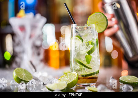 Mojito cocktail Drink auf Bartheke mit Barmann Holding Shaker auf Hintergrund Stockfoto