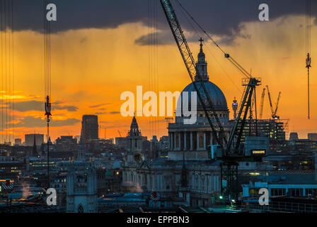 Stadtbild von Silhouette Krane auf der Bloomberg Platz Baustelle, London EG4, in die untergehende Sonne mit St Pauls Cathedral Stockfoto