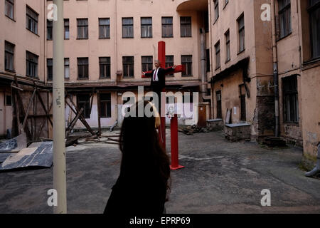 Besucher sehen die Kunstinstallation eines lettischen Künstlers, der anonym bleibt, mit einem Bildnis von Präsident Wladimir Putin, der gekreuzigt wird, das Besucher dazu einlädt, Nägel in die Holzpuppe zu treiben, die im Hof des ehemaligen KGB aufgestellt wurde, Oder „Cheka“-Hauptquartier und Gefängnis, bekannt unter den Einheimischen als das Eckhaus in der Hauptstadt der Republik Lettland in Riga. Etwa 26 Prozent der Bevölkerung in Lettland, einer postsowjetischen baltischen republik mit rund 2 Millionen Einwohnern, ist ethnisch russisch. Moskau behauptet, dass die lettischen Behörden ihre russischsprachige Gemeinschaft diskriminieren. Stockfoto