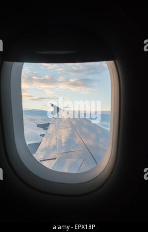Flügel des Flugzeugs durch Flugzeugfenster gesehen Stockfoto