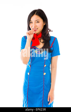 Asiatische Luft Stewardess mit Finger im Mund Stockfoto