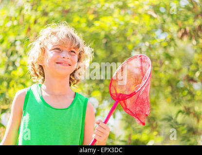 Jungen (8-9) Holding Schmetterlingsnetz Stockfoto