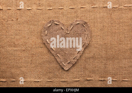 Herz des Sackleinen gemacht auf Entlassung Hintergrund liegt, kann als Textur verwendet werden Stockfoto