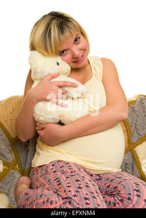 Schwangere Frau im Bett. Weißem Hintergrund Stockfoto