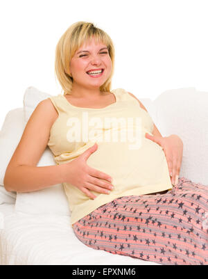 Schwangere Frau im Bett. Weißem Hintergrund Stockfoto