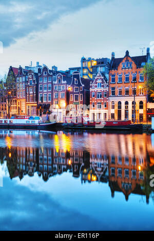 Nacht-Stadtansicht von Amsterdam in den Niederlanden mit dem Fluss Amstel Stockfoto