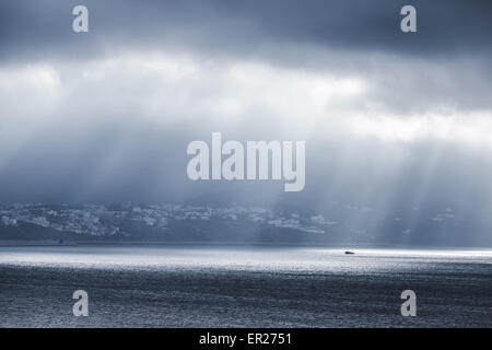 Volume Sonnenlicht geht durch dunkle stürmischen Wolken. Bucht von Tanger, Marokko, Afrika Stockfoto