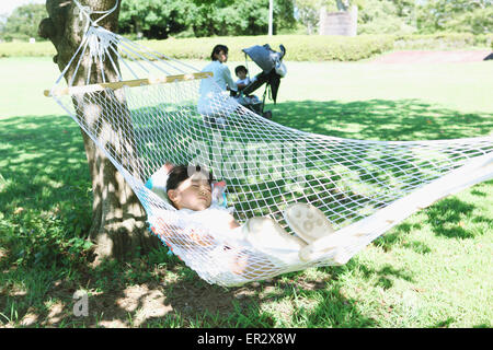 Japanische Mutter mit Kindern in einem Stadtpark Stockfoto