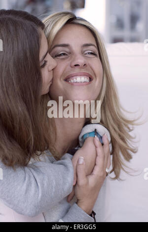 Mädchen küssen Mutter Wange Stockfoto
