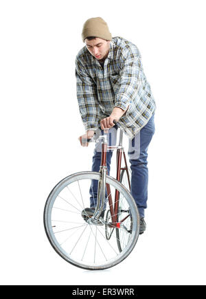 Junger Mann tut Tricks auf fixed-Gear Fahrrad auf weißem Hintergrund Stockfoto