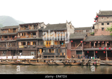 FENGHUANG - Mai 12: Holzboot und Holzhäuser am Tuojiang Fluss in Fenghuang alte Stadt am 12. Mai 2011 in Fenghuang, Kinn Stockfoto