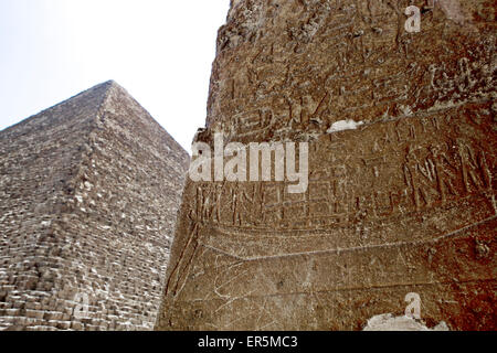 Wand bedeckt mit Hieroglyphen, Pyramide im Hintergrund, Giza, Gizeh Governorate, Ägypten Stockfoto