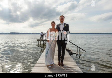 Brautpaar ist Fuß entlang der Mole, Starnberger See, Bayern, Deutschland Stockfoto