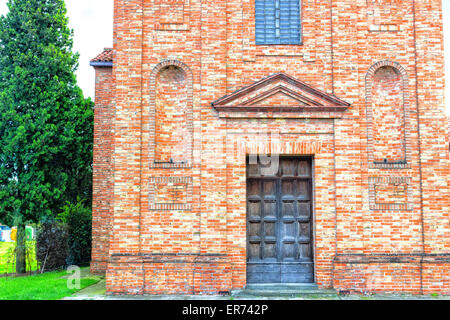 Architektur-Details der Brickwall Fassade eine XVIII Jahrhundert Seelsorge, Kirche im Dorf von Cà di Lugo in der Nähe von Ravenna in der Landschaft der Emilia Romagna in Norditalien: die Kirche wurde wieder aufgebaut nach dem Ende des zweiten Weltkrieges Stockfoto