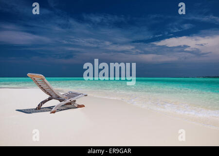 Strand-Blick auf erstaunliche Wasser auf den Malediven - leeren Stuhl auf sand Stockfoto