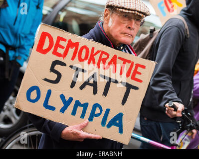 Hamburg-Wilhelmsburg, Deutschland. 30. Mai 2015. Ein Mitglied einer Kampagne Gruppe gegen Hamburg Ausrichtung der Olympischen Spiele 2024 hält ein Schild liest "Demokratie Statt Olympia" (lit.) Demokratie statt Olympics) während einer Demonstration in Hamburg-Wilhelmsburg, Deutschland, am 30. Mai 2015. Foto: DANIEL BOCKWOLDT/DPA/Alamy Live-Nachrichten Stockfoto