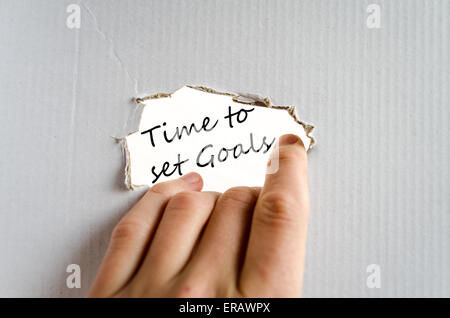 Hand und Text auf dem Karton Hintergrund Zeit Ziele zu setzen Stockfoto