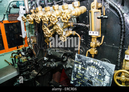 Die Bedienelemente in der Fußplatte des Zuges eines alten Dampflokomotive im Osaka Transport Museum. Goldbeschlabte Drehventile und andere Bedienelemente. Stockfoto