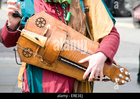 Frau spielt eine Drehleier Gurdy in ausgefallenen Kostüm, die Teilnahme an der St. Georges Day Feierlichkeiten in der Stadt-Zentrum-Marktplatz, Stockfoto
