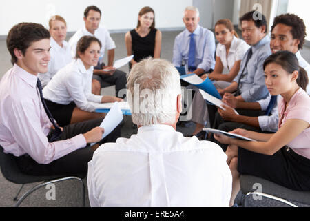 Geschäftsleute, die sitzen im Kreis auf Firmenseminar Stockfoto