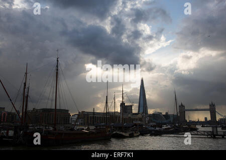 Die Scherbe drohend über Liegeplätze auf der Themse an bewölkten und stürmischen Tag in London, Vereinigtes Königreich.  Die Scherbe, auch genannt der Shard of Glass, Shard London Bridge und London Bridge Tower, früher ist eine 87-geschossiges Hochhaus in London Teil der London Bridge Quartal Entwicklung. Stockfoto