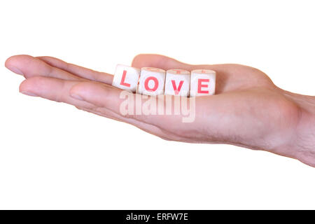 Das Wort Liebe mit hölzernen Würfel auf die He Palme der Hand geschrieben. Isoliert auf weißem Hintergrund Stockfoto