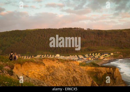 Wanderer bei Sonnenuntergang auf der Wales Coast Path bei Clarach Mitte Wales. Stockfoto