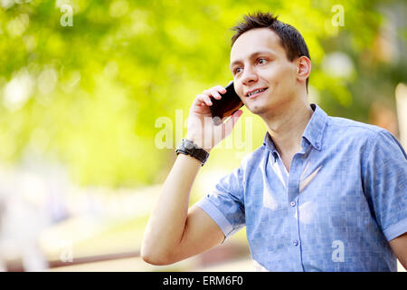 hübscher junger Mann sprechen auf dem Handy Stockfoto