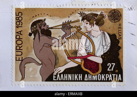 Vintage Briefmarke zeigt Satyr Marsyas griechischen Mythologie mit Aulos Doppel Flute Musik Herausforderung gegen Apollo. Stockfoto