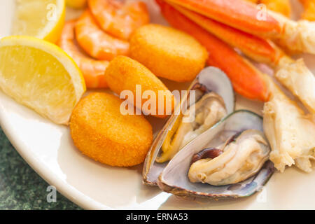 Meeresfrüchte-Medley einschließlich Krabbenbeine panierte Garnelen Muskeln und gebratenen Jakobsmuscheln Stockfoto