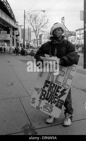 Chicago, IL, 14. Dezember 1996: ein afroamerikanischer junge ist die Werbung für ein Restaurant in Uptown Chicago. Stockfoto