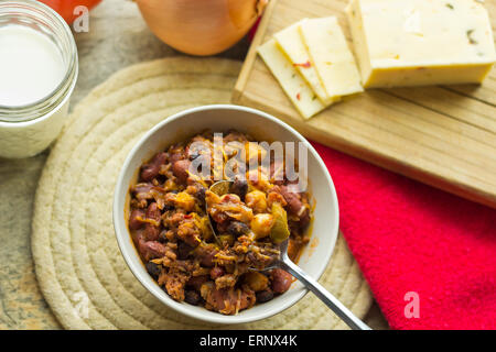 Scharf und würzig Chili Con Carne mit einem Glas Milch und Pfeffer Jack Käse Stockfoto