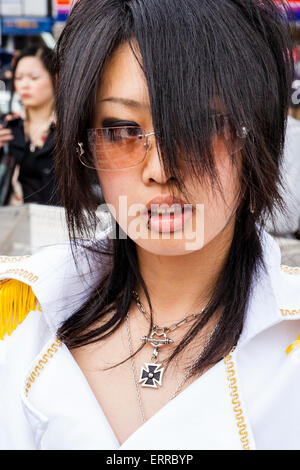 Nahaufnahme von Kopf und Schulter japanischer junger Frauen, die sich in einer Uniform im weißen Militärstil bekleidet haben und ein eisernes Kreuz um den Hals tragen. Harajuku, Tokio. Stockfoto