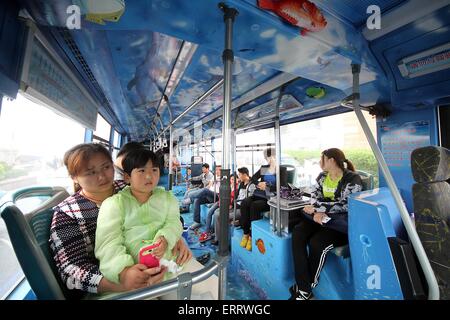 Qingdao, China Shandong Provinz. 8. Juni 2015. Menschen nehmen einen Bus mit Gemälden zum Thema des Ozeans in Qingdao-Stadt in der ostchinesischen Provinz Shandong, 8. Juni 2015. Bildnachweis: Lin Xiaomu/Xinhua/Alamy Live-Nachrichten Stockfoto