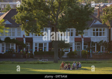 Freunden picknicken Sommer Abend an einem Sommerabend vor der Edwardian Periode Häuser in Ruskin Park, Süd-London. Stockfoto