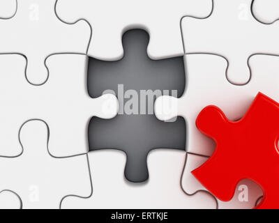 Red puzzle-Teil fehlt unter weißen Puzzleteile Stockfoto
