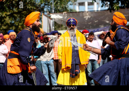 Nihang oder Sikh Krieger Durchführung Stunts mit Schwert und Schild in während Hola Mohalla feiern bei Anandpur sahib Stockfoto