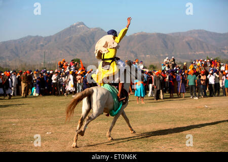 Nihang oder Sikh Krieger Reiten auf Pferd während Hola Mohalla Festivals bei Anandpur Sahib Stunts ausführen Stockfoto