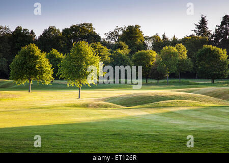 Ein Bunker auf einem typischen Golfplatz in der frühen Morgensonne. Stockfoto