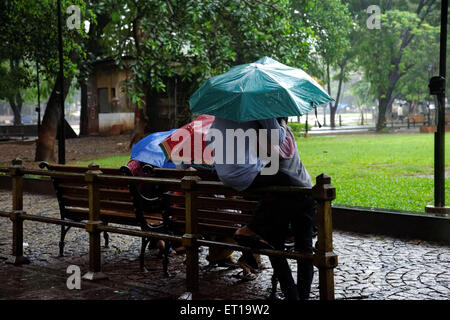 Romanische junges Paar genießen Monsun-Regen im Garten Stockfoto